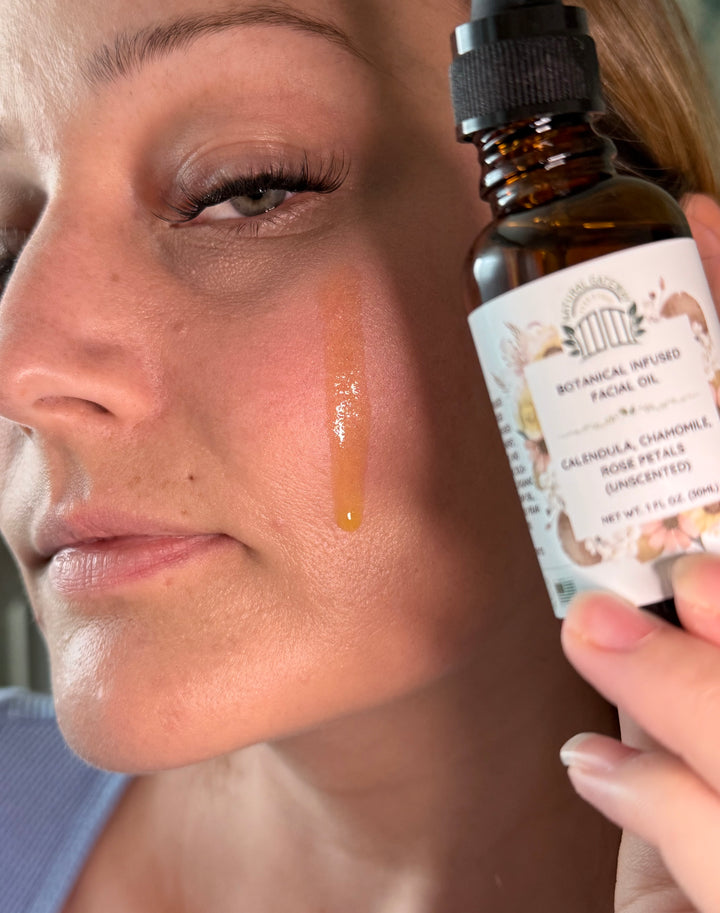 Person applying facial oil to their face with a dropper bottle labeled ‘Botanical Facial Oil’