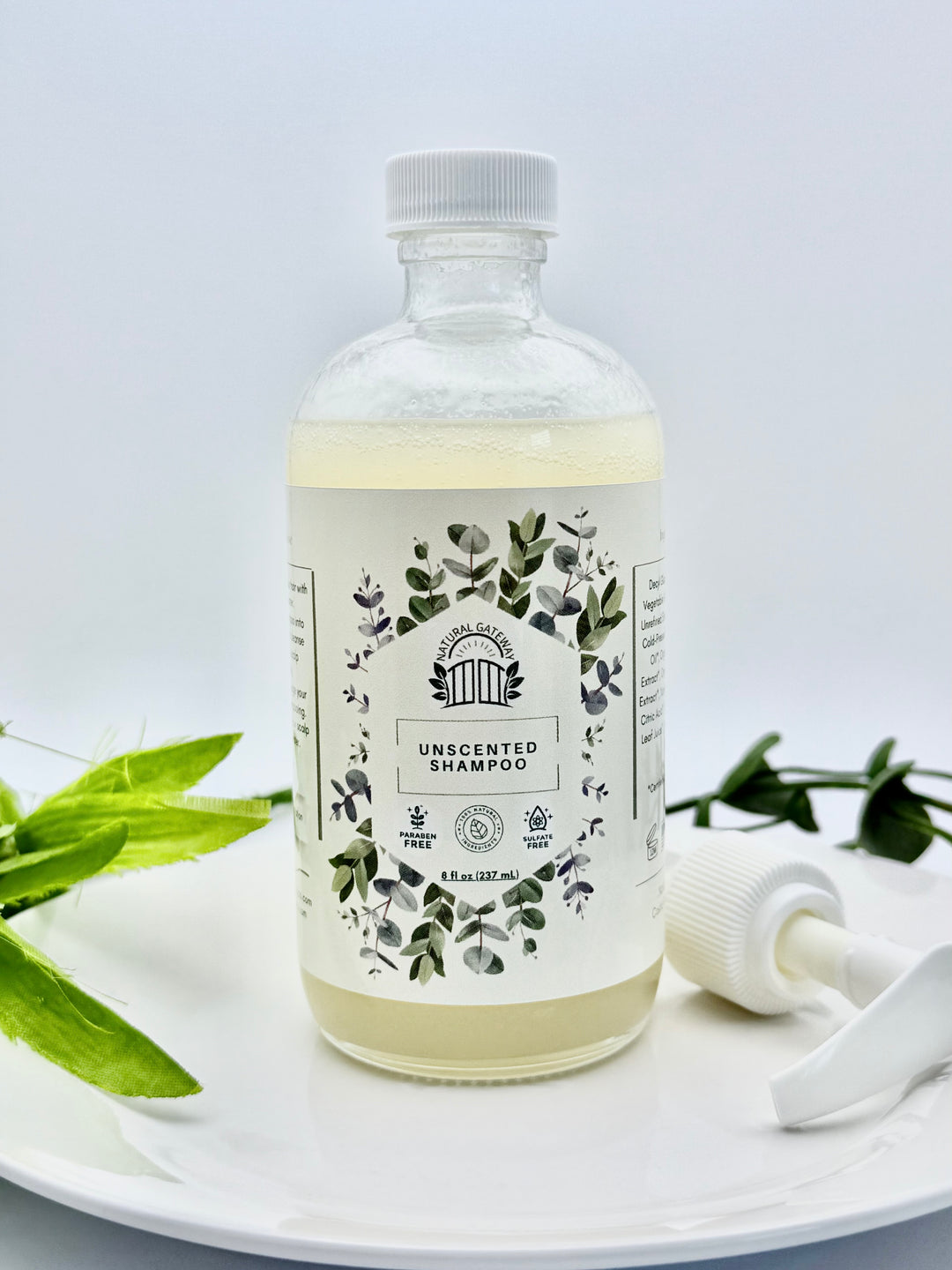 Glass Bottle of unscented shampoo with a white pump 